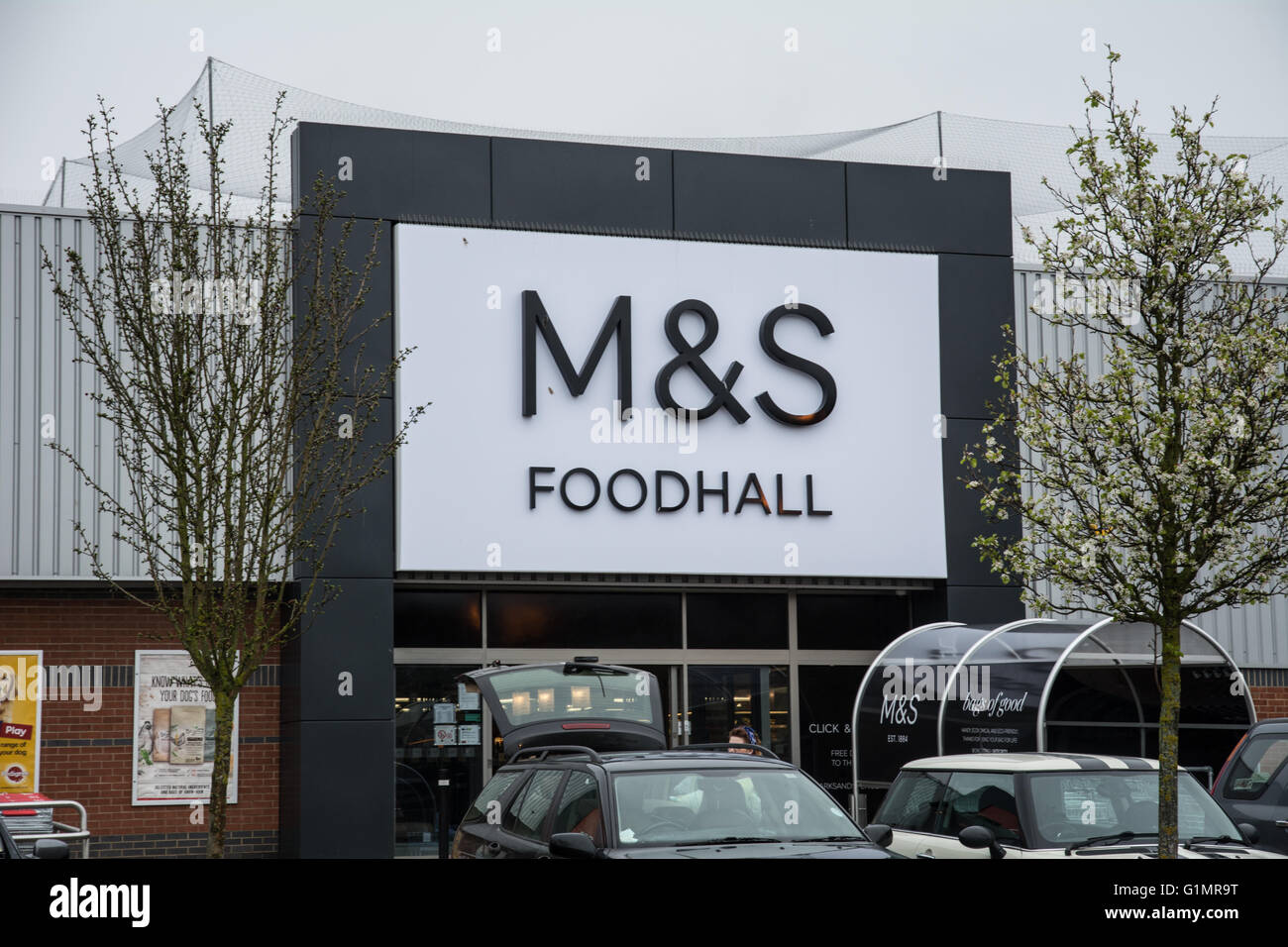 The M&S Foodhall with cars parked in front and an open boot. Stock Photo