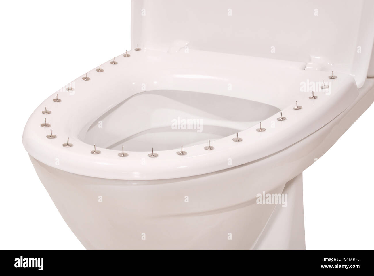Thumbtacks on the lid of the toilet on white. Clipping path included. Stock Photo