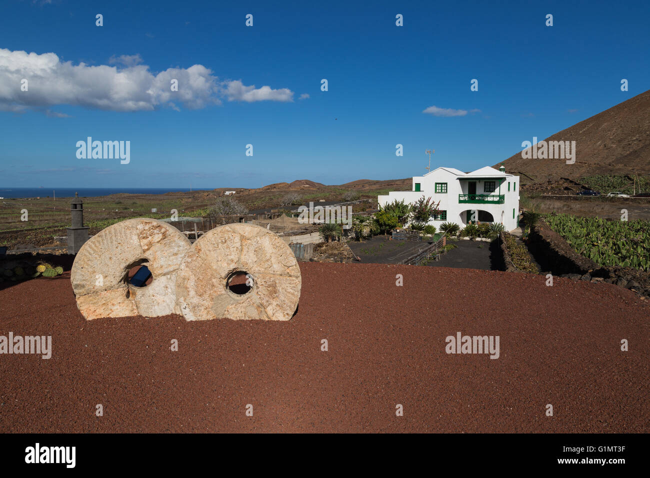 Two millstones in front of a white Spanish House on Lanzarote Stock Photo