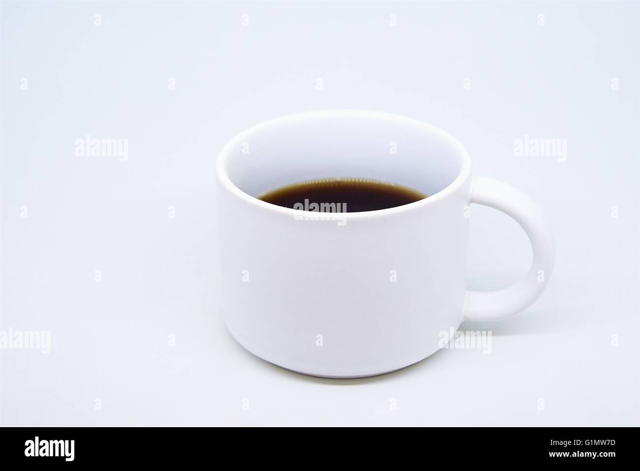 Morning fresh strong coffee in a white little mug. Stock Photo