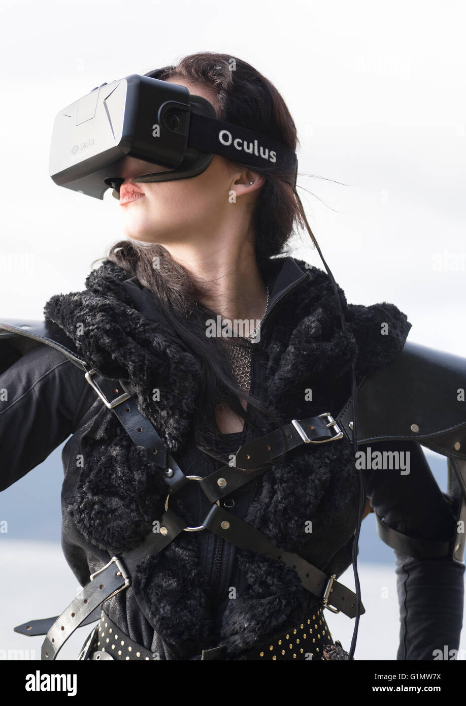 Conceptual picture of a young woman wearing costume and Oculus Rift Virtual Reality headset Stock Photo