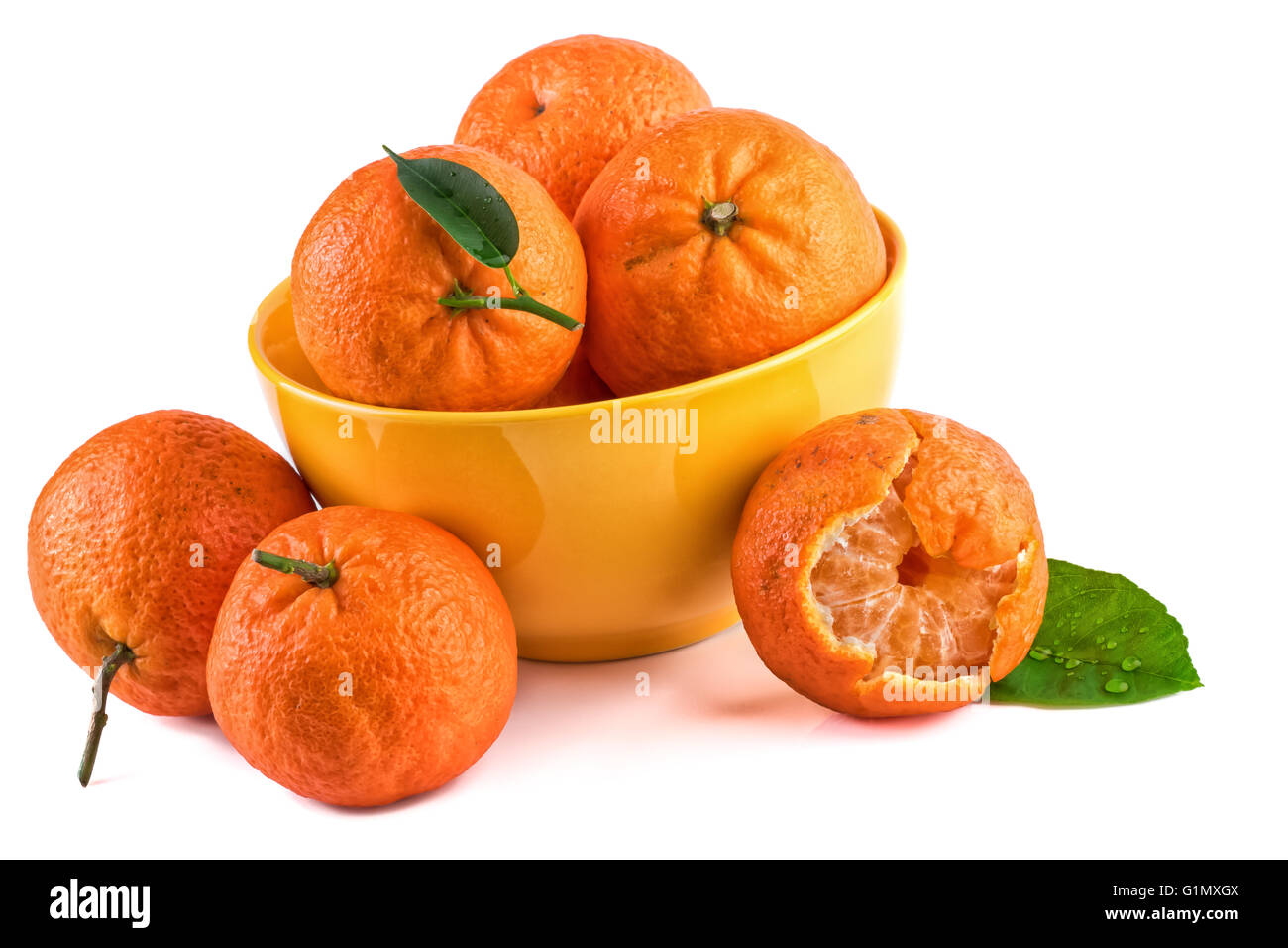 Tangerines mandarins in yellow cup isolated on white. Closeup Stock Photo Alamy
