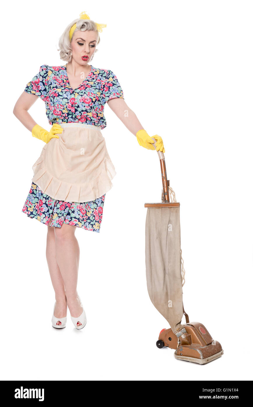 Retro housewife, with vintage vacuum cleaner, isolated on white Stock Photo