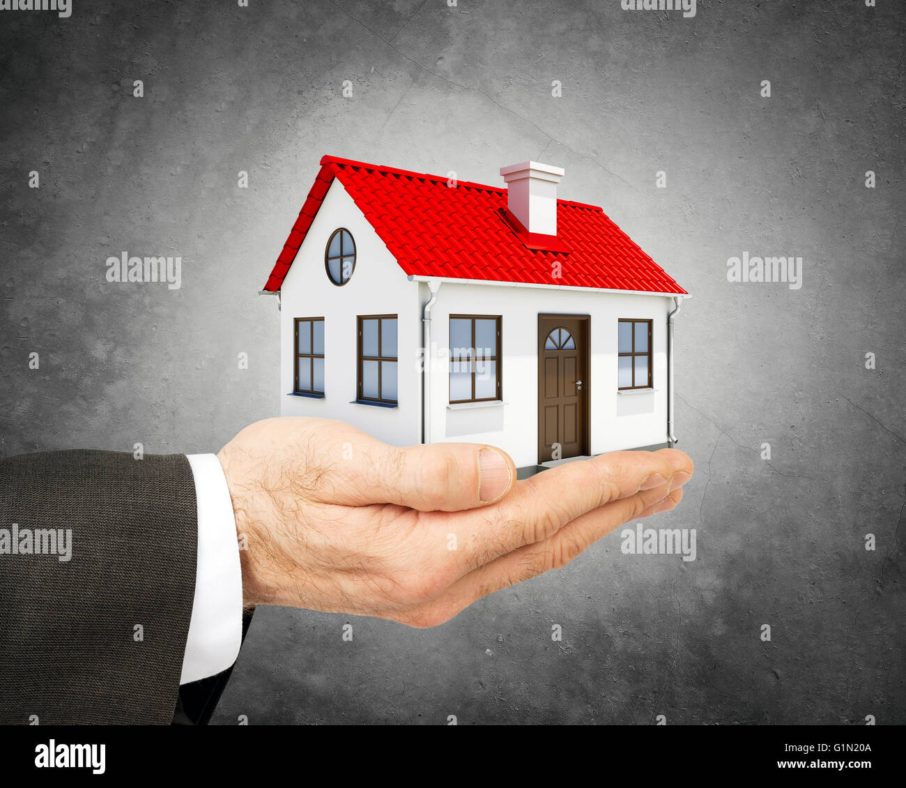 Business man holding model house Stock Photo - Alamy
