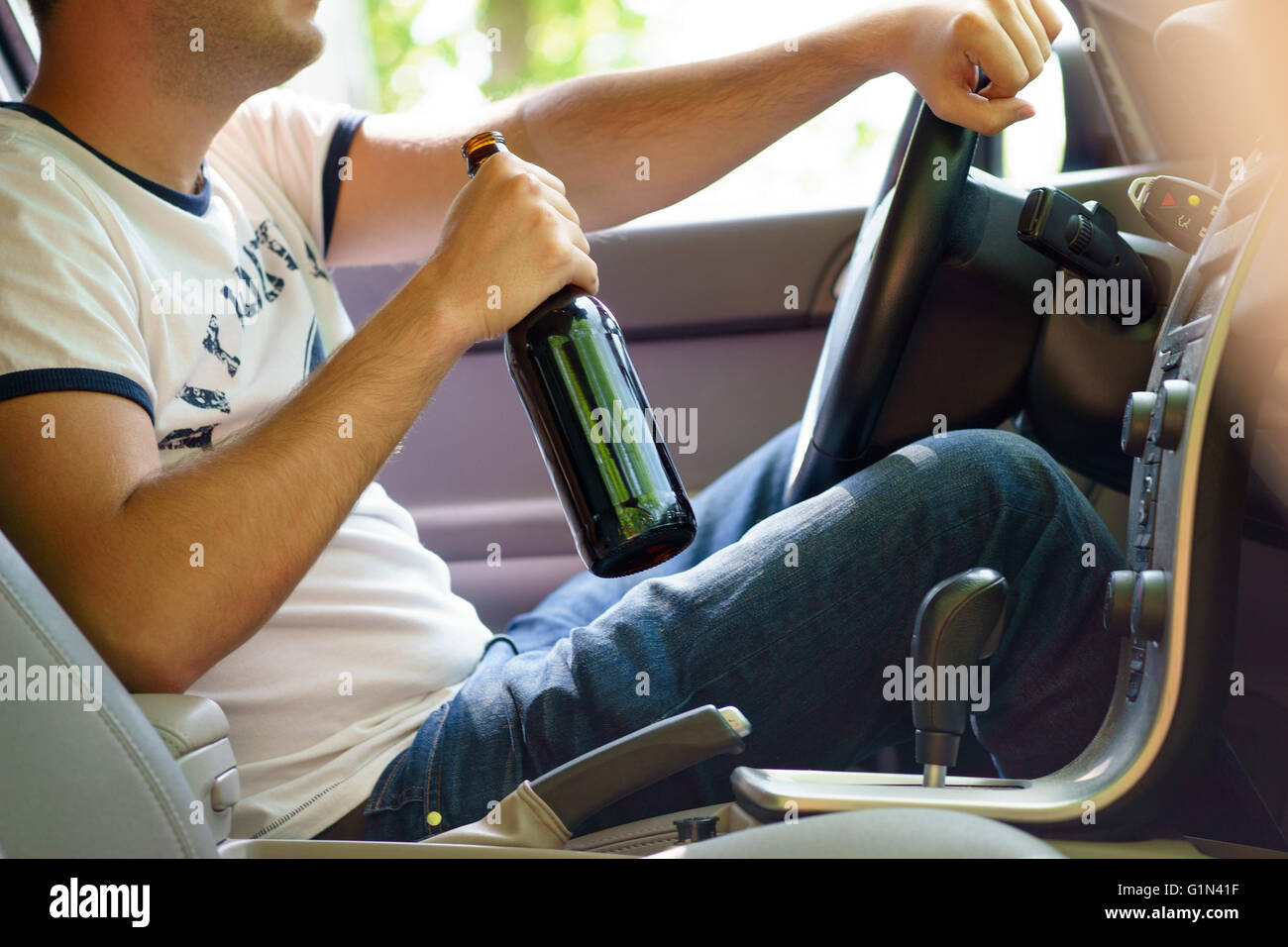 Man drinking beer while driving the car Stock Photo Alamy