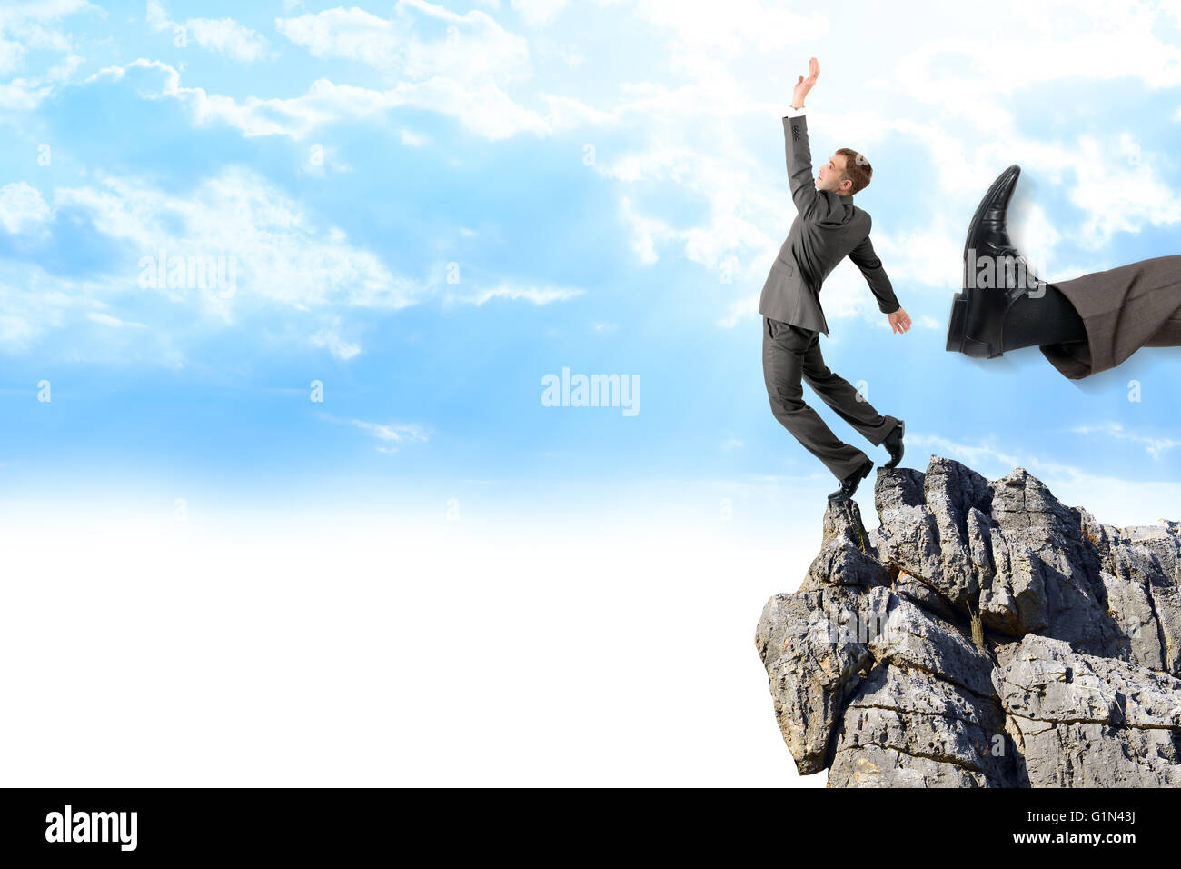 Businessman kicked by his boss big foot Stock Photo