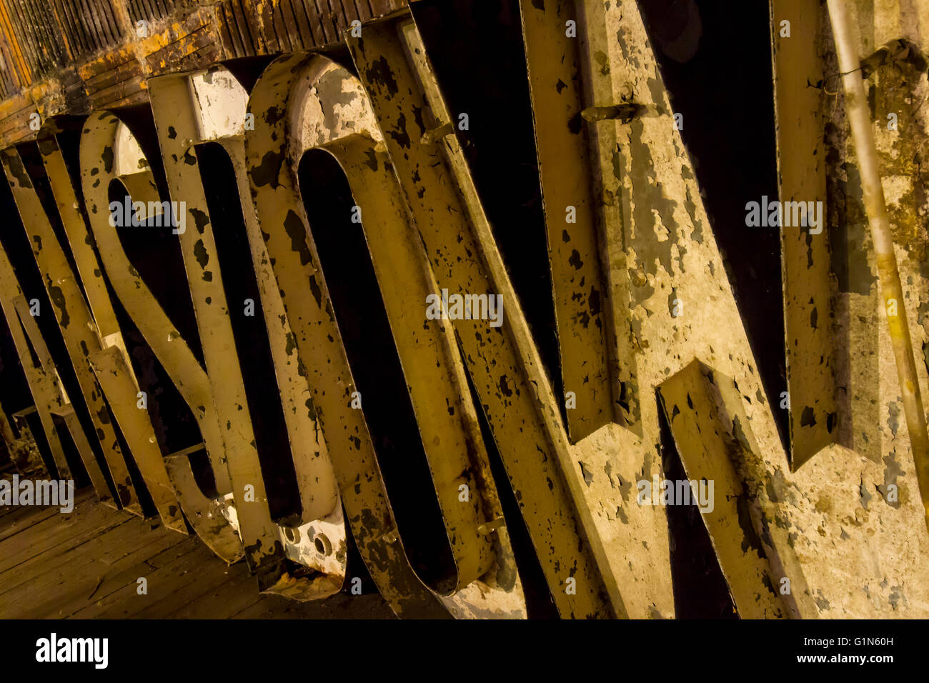 Aging and decaying block neon sign lights in old brick theater. stage Stock Photo