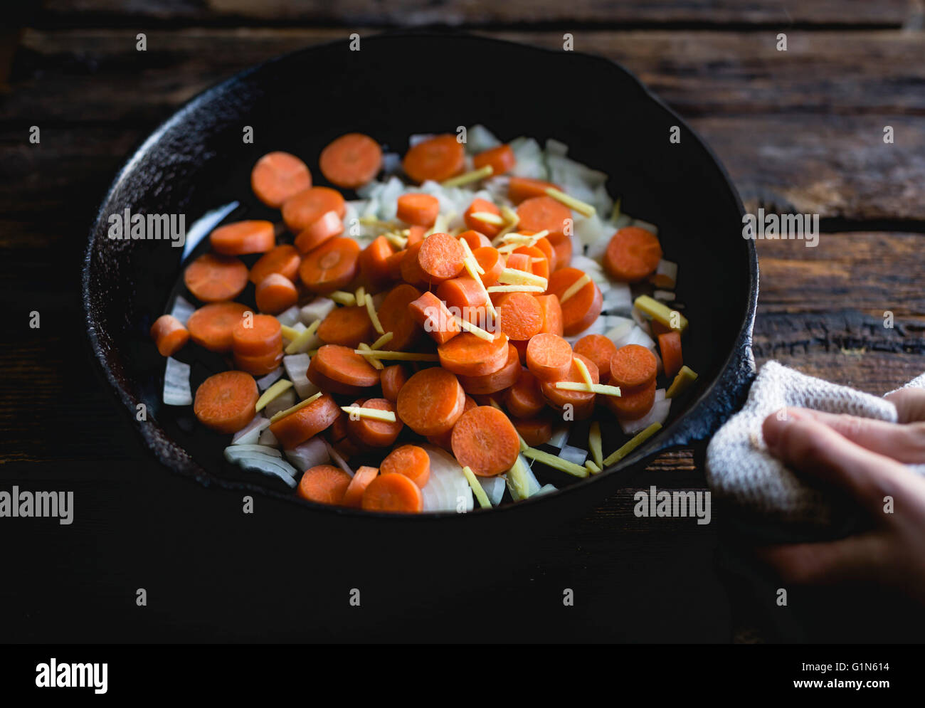 Carrots, onions and ginger in a saucepan Stock Photo