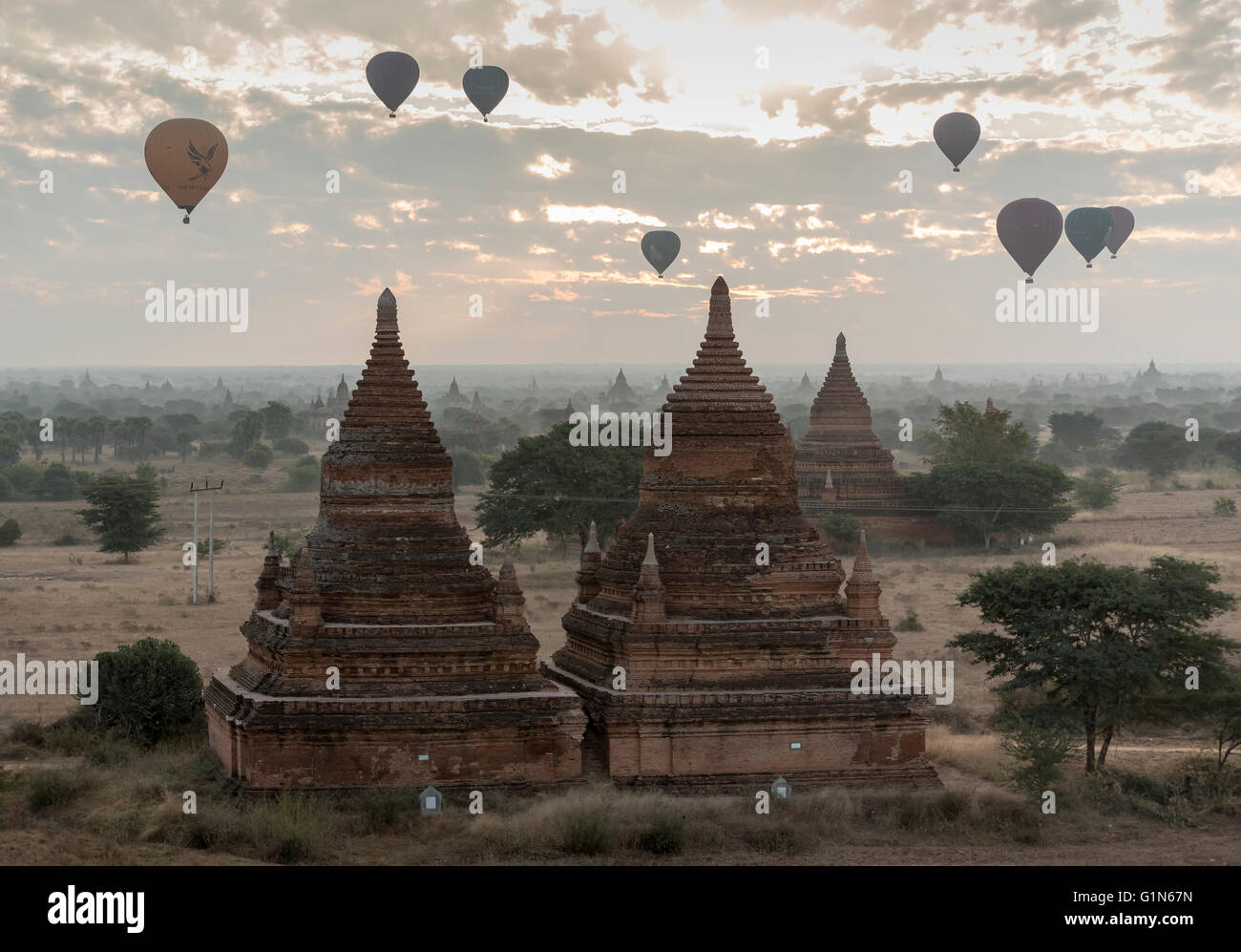 Hot-air Balloons in flight over temples of Bagan as seen from Buledi Pagoda, Burma - Myanmar Stock Photo
