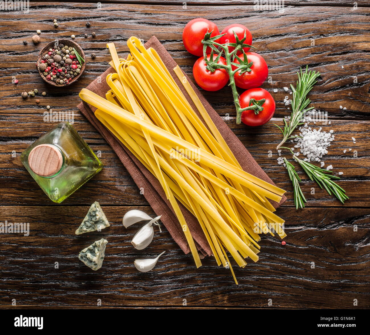 Pasta ingredients. Cherry-tomatoes, spaghetti pasta, rosemary and ...