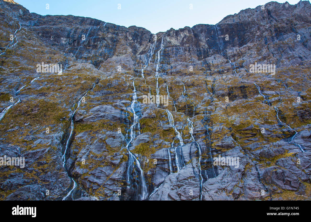 Waterfalls Flowing Down Mountains From Snowtops In New Zealand Stock waterfalls-flowing-down-mountains-from-snowtops-in-new-zealand-stock