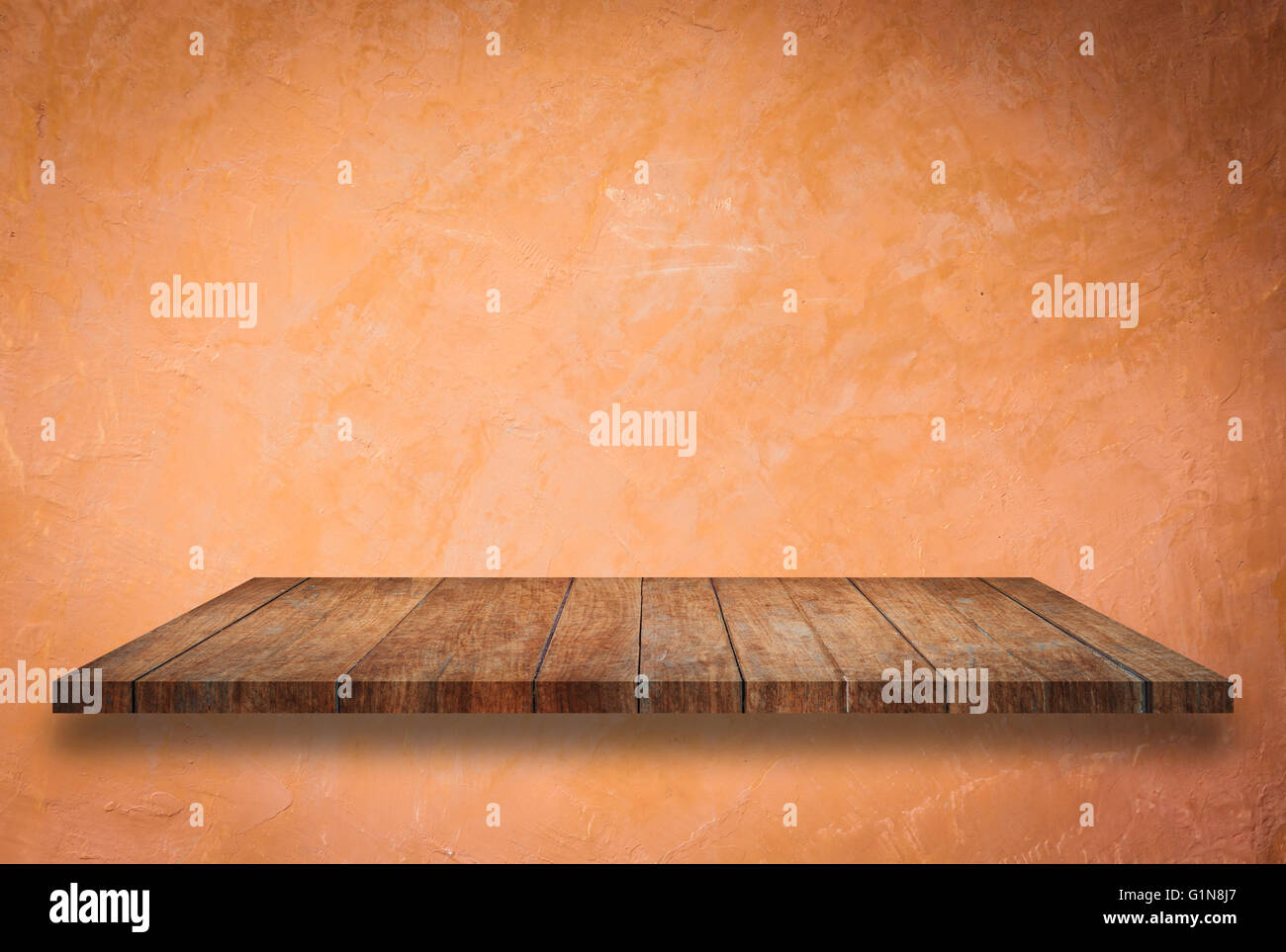 Empty perspective top wooden shelf on orange wall background Stock Photo