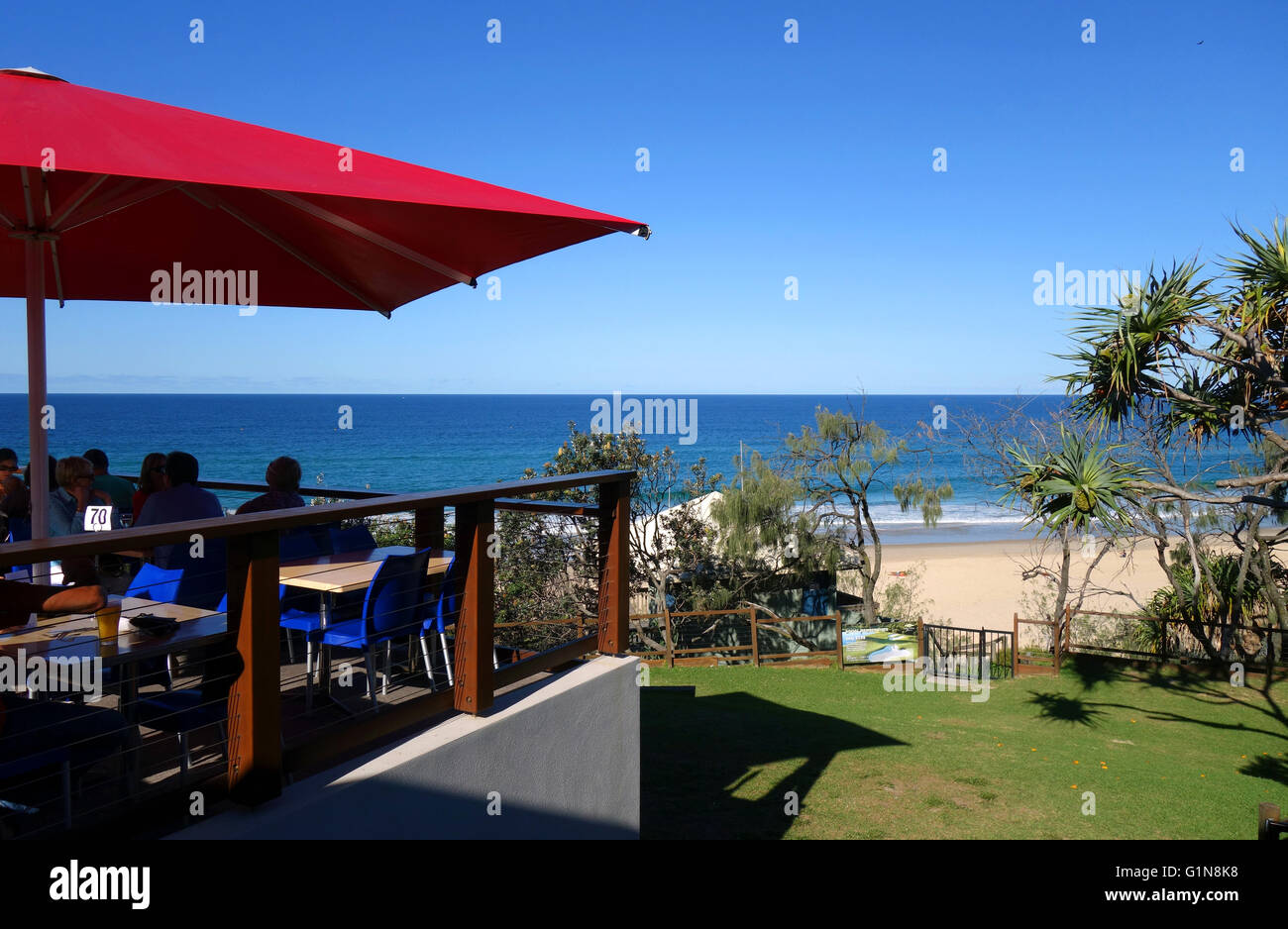 People eating and drinking on deck overlooking beach, Sunshine Beach Surf Lifesaving Club, Sunshine Coast, Queensland, Australia Stock Photo