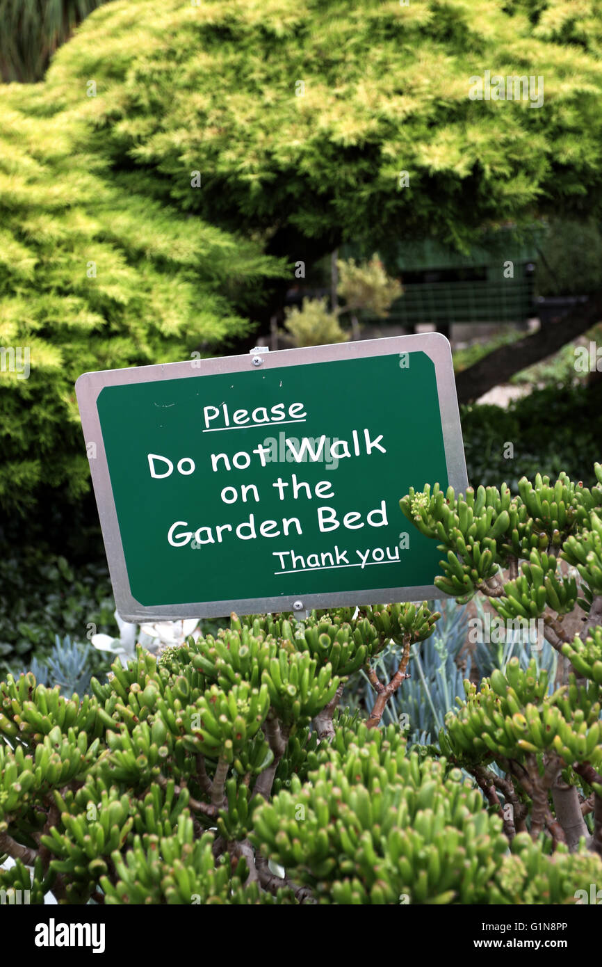 'Do not walk on the garden bed' sign near the succulent garden Stock Photo