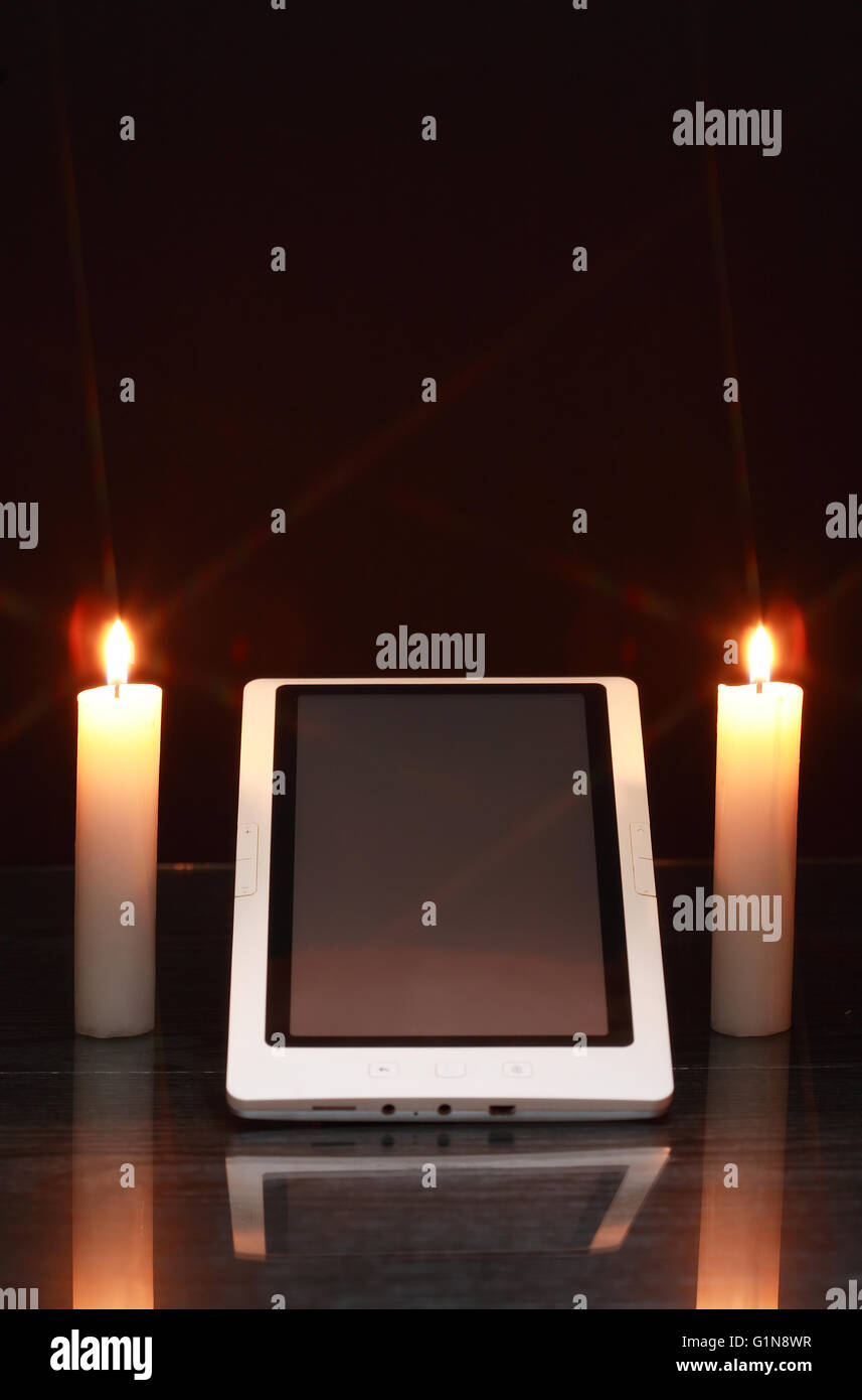 https://c8.alamy.com/comp/G1N8WR/blackout-concept-lighting-candles-around-tablet-like-a-sanctuary-G1N8WR.jpg