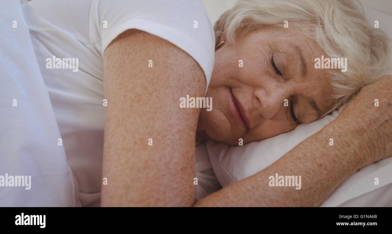 Senior woman sleeping in her bed Stock Photo