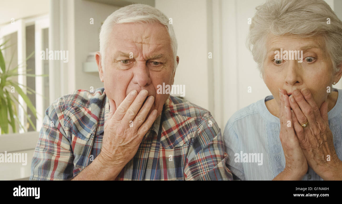 Shocked senior couple looking Stock Photo