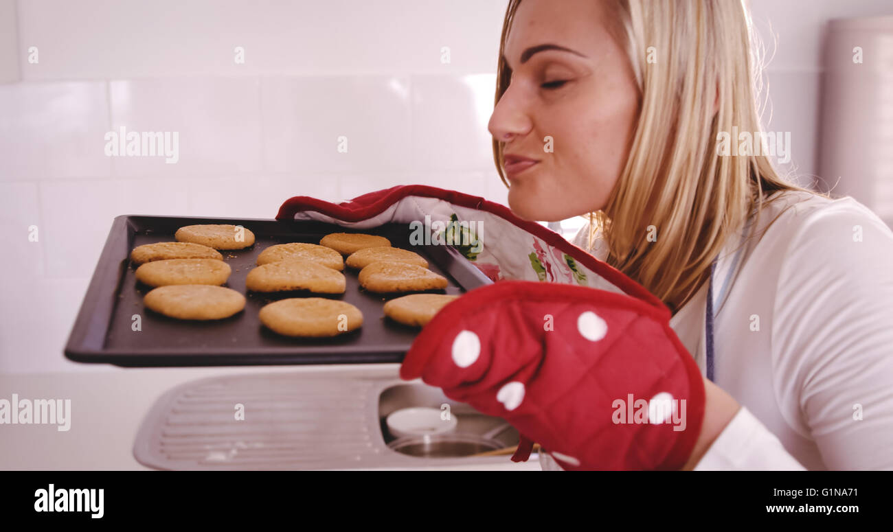 Profile view of woman is smelling her cakes Stock Photo