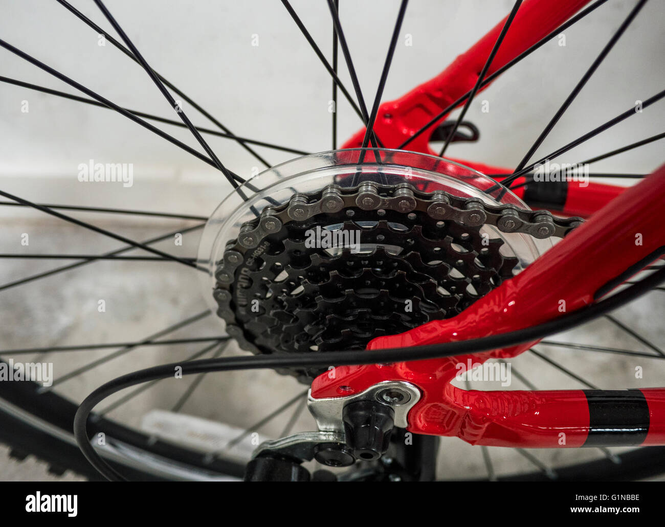 A close up of bike gears and chain on a red mountain bike or bicycle. Stock Photo