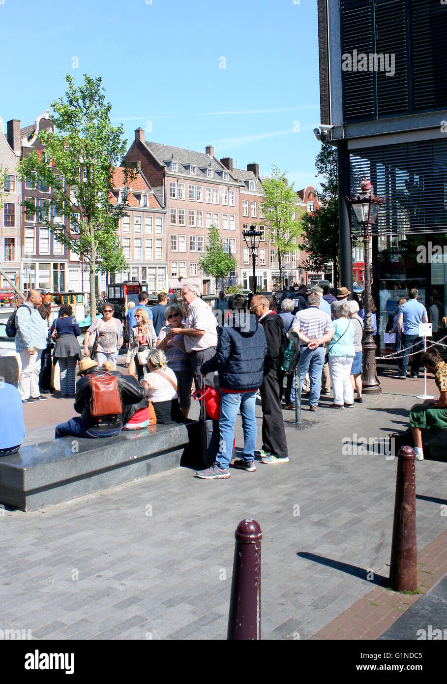 Group of foreign  tourists waiting to enter the Anne Frankhuis - Anne Frank Museum, Prinsengracht canal, Amsterdam. Stock Photo