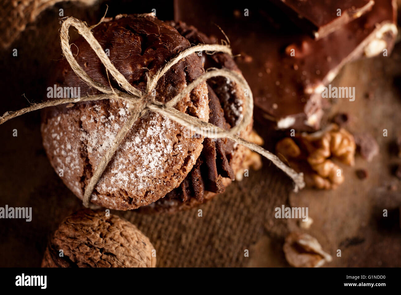 Italian maroni cookies with pieces of chocolate and walnuts on old wooden background Stock Photo