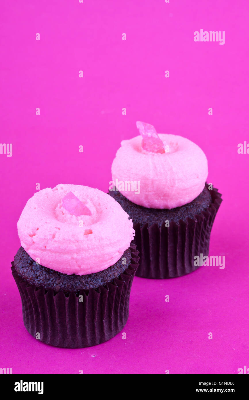Cupcakes on a pink background Stock Photo - Alamy