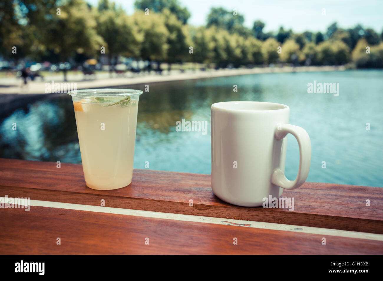 Drinks by the lake in a park on a summer day Stock Photo