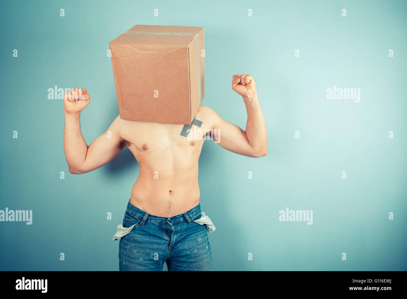 A young man is standing with a cardboard box on his head Stock Photo ...
