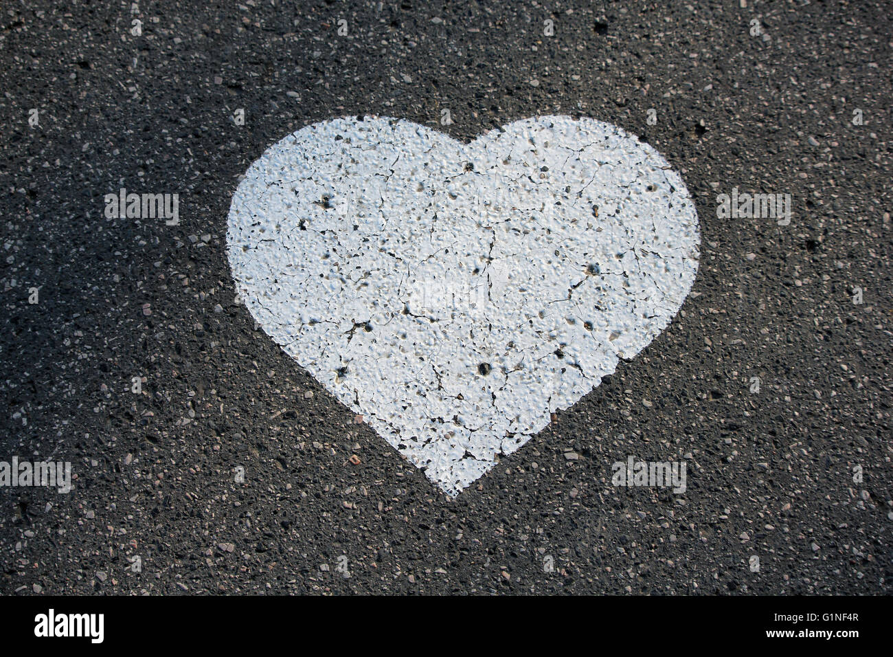 White heart shape painted on the street asphalt Stock Photo
