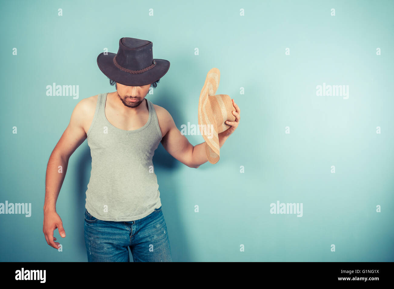 Man with two hats hires stock photography and images Alamy