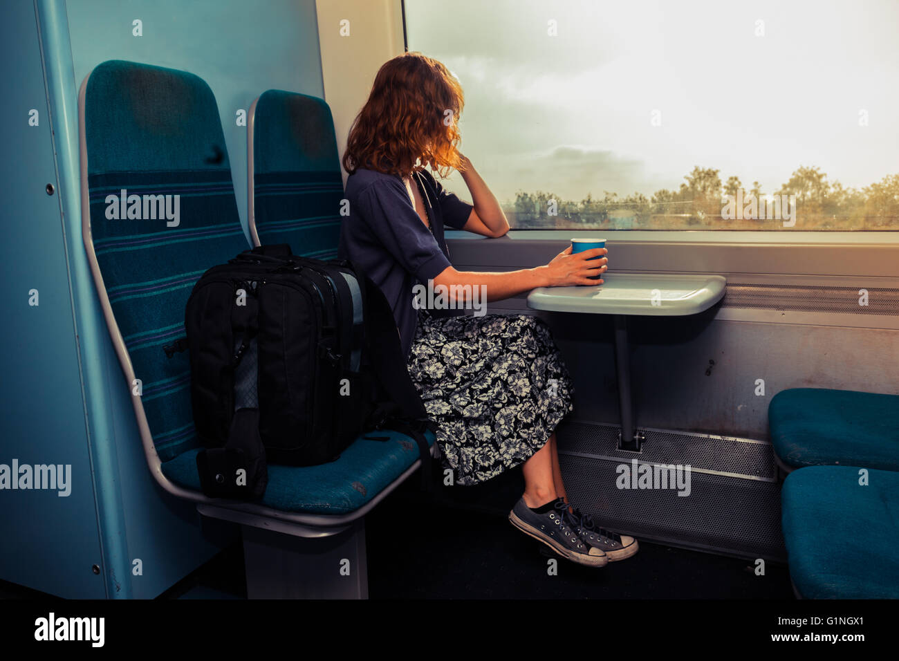Woman commuter train happy hi-res stock photography and images - Alamy