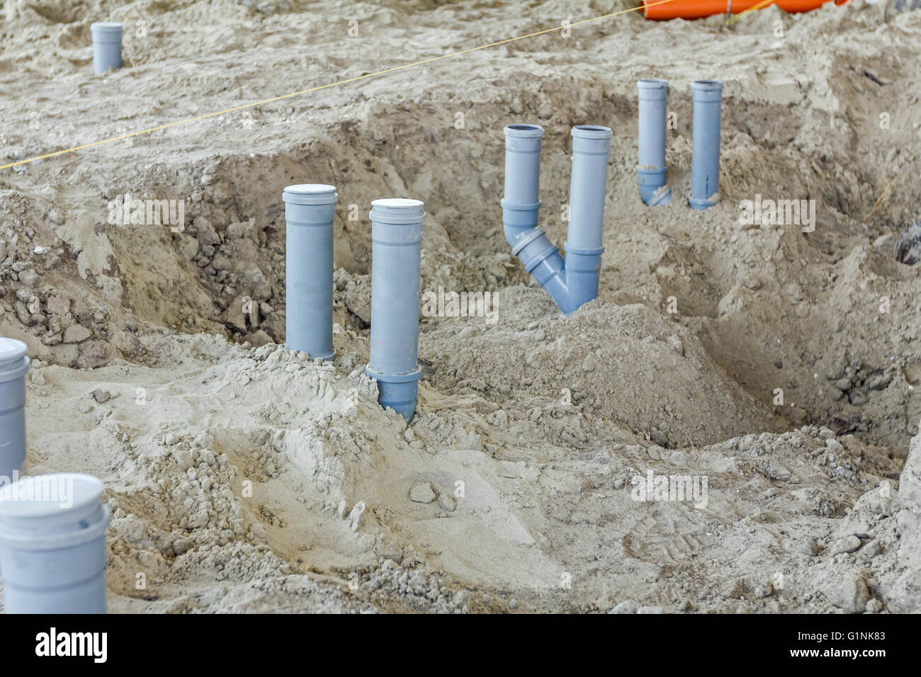 Set of waste pipes are assembled and lined up on building site Stock