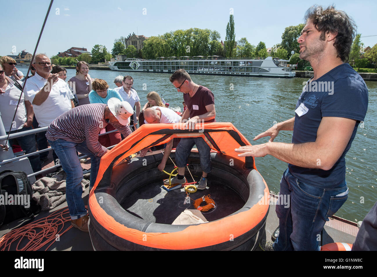 Regensburg, Germany. 7th May, 2016. Michael Buschheuer, initiator of the refugee initiative 'Sea Eye' from Regensburg, explaining a rescue island during a training mission at Donau river in Regensburg, Germany, 7 May 2016. The participants of 'Sea-Eye', a private rescue initiative for refugees experiencing distress at sea, practiced rescue missions in Regensburg. PHOTO: ARMIN WEIGEL/dpa/Alamy Live News Stock Photo
