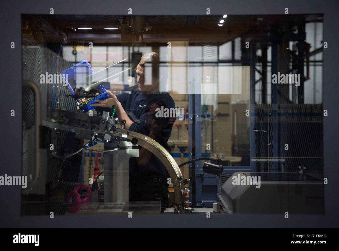 Goeppingen, Germany. 4th Mar, 2016. An employee of Schuler AG filling a ...