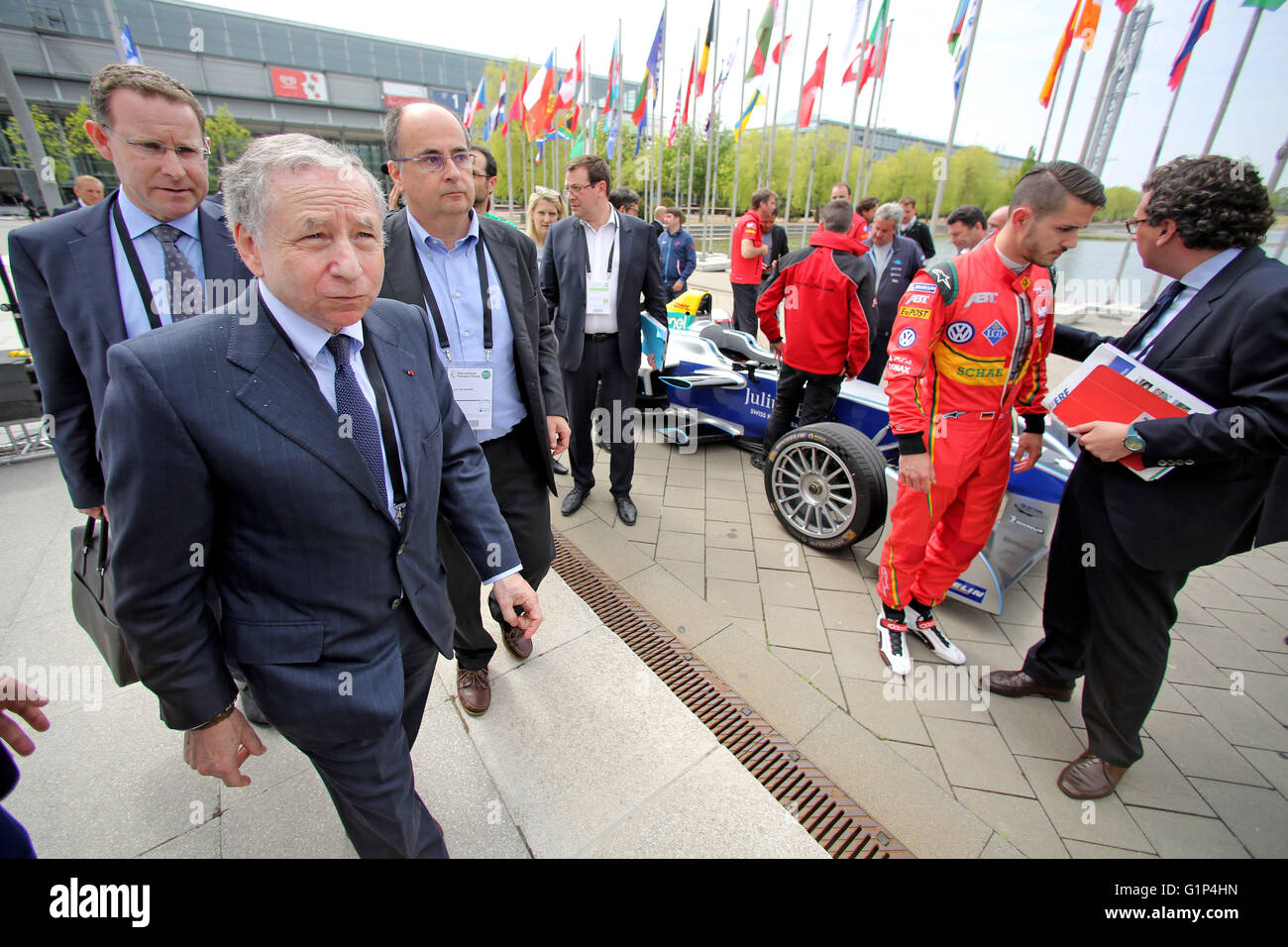 Leipzig, Germany. 18th May, 2016. Jean Todt (front L), president of the International Automobile Federation (FIA), heads to the opening ceremony of the world summit of transport ministers after the presentation of an electric Formula E racing car in Leipzig, Germany, 18 May 2016. Some 1,000 participants from 60 countries are expected to attend the three-day summit held by the International Transport Forum of the Organisation for Economic Co-operation and Development (OECD). Photo: JAN WOITAS/dpa/Alamy Live News Stock Photo