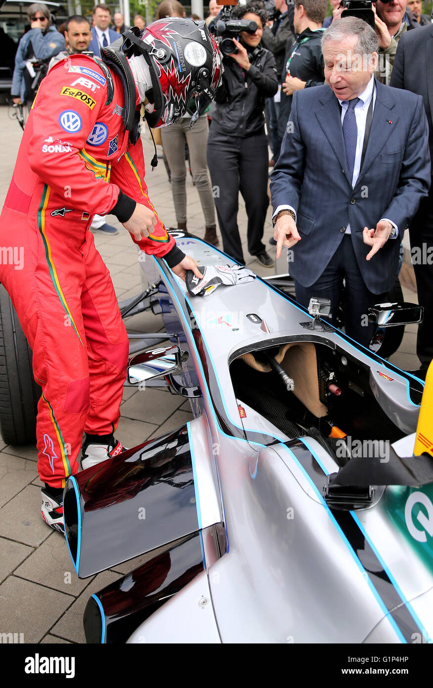 Leipzig, Germany. 18th May, 2016. Jean Todt (front R), president of the International Automobile Federation (FIA), speaks to racing driver Daniel Abt (L) during the presentation of an electric Formula E racing car at the world summit of transport ministers in Leipzig, Germany, 18 May 2016. Some 1,000 participants from 60 countries are expected to attend the three-day summit held by the International Transport Forum of the Organisation for Economic Co-operation and Development (OECD). Photo: JAN WOITAS/dpa/Alamy Live News Stock Photo