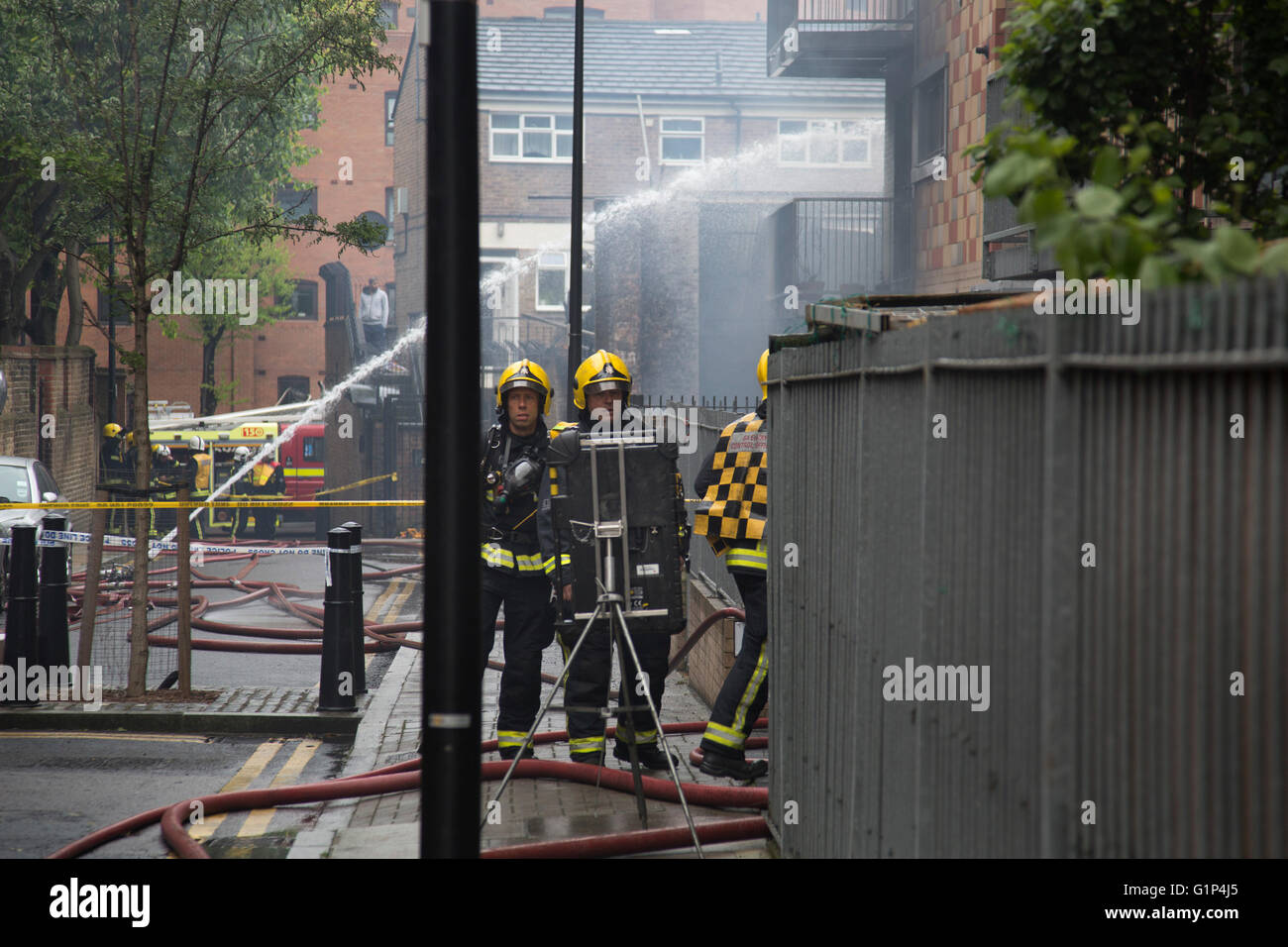 Fire fighters tackle a fire in a block of flats in Brodlove Lane in Wapping, London, United Kingdom. According to sources the fire was possibly due to gas cylinders which were in a builders yard at the base of the building. A local resident said that there were often fires in this area, though he didn't know what was the cause. Stock Photo