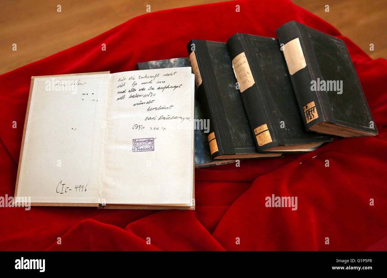 Rostock, Germany. 18th May, 2016. Stolen books from the inventory of the Rostock university library seen at the restitution ceremony to heiress Audrey Goodman of the USA, in Rostock, Germany, 18 May 2016. A project supported by the German Lost Art Foundation was launched to locate the German Nazi plunder goods. The nine books were wrongfully seized by the Nazis and subsequently exchanged or donated to the Rostock university library. Photo: BERND WUESTNECK/dpa/Alamy Live News Stock Photo