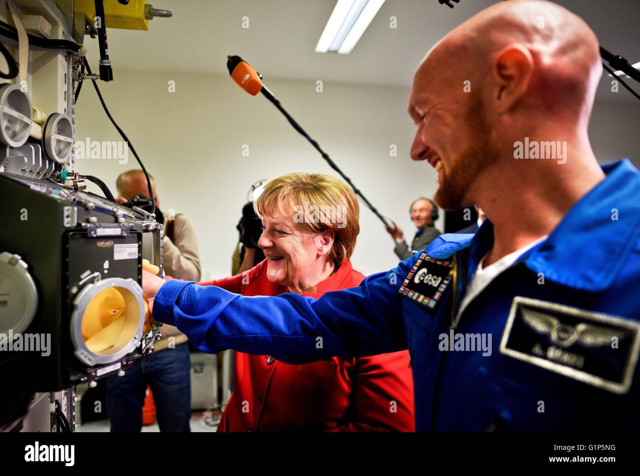 German Chancellor Angela Merkel (L) and astronaut Alexander Gerst watch the Bio Lab at he European Astronaut Centre (EAC) in Cologne on May 18, 2016. Credit:  dpa picture alliance/Alamy Live News Stock Photo