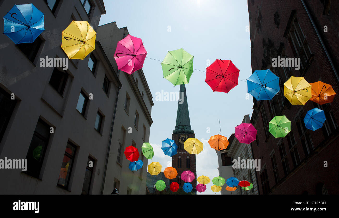 Luebeck, Germany. 18th May, 2016. Colourful umbrellas hanging in an alley in the historic
