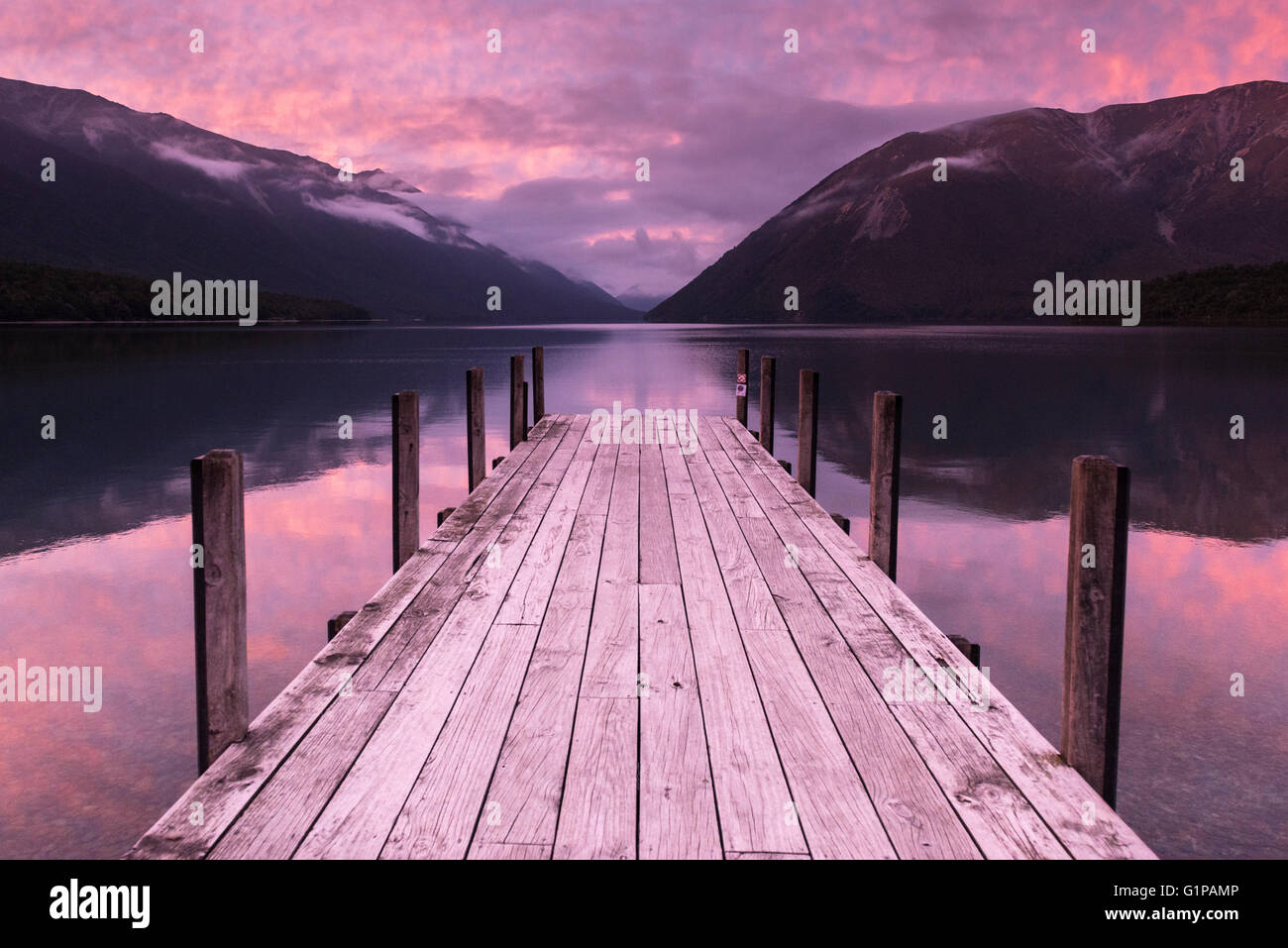 Iconic South Island, New Zealand. Dawn over the jetty on Lake Rotoiti and the hills of Nelson Lakes National Park including Mount Robert, New Zealand Stock Photo