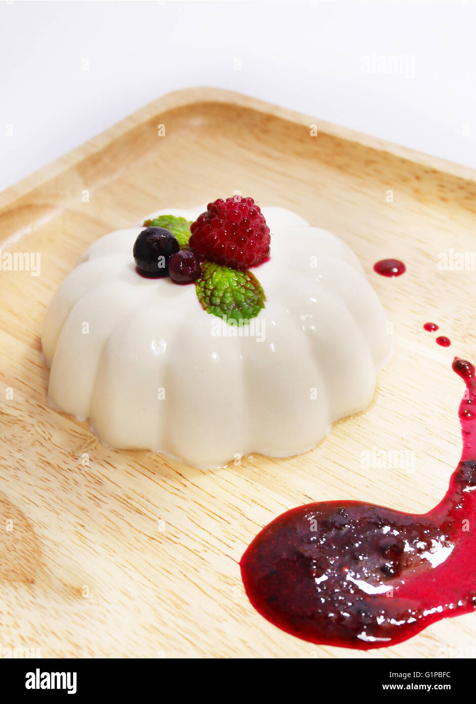 Panna cotta with mixed berry sauce Stock Photo Alamy