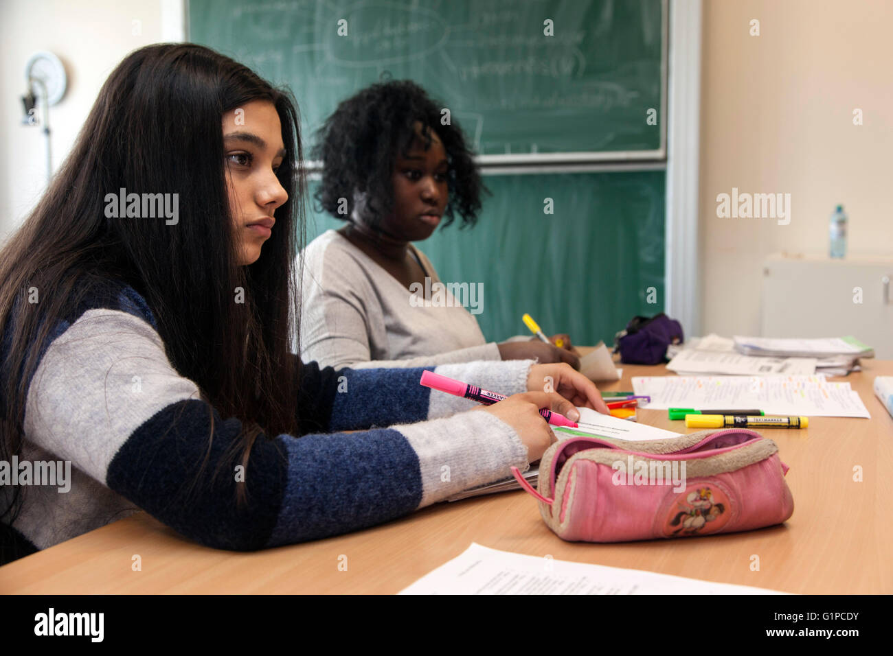 Students in the classroom during a writing task. Stock Photo