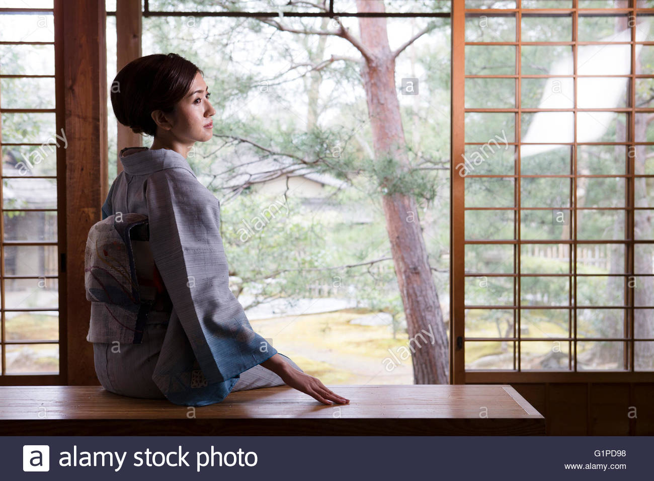 Young Woman In Kimono Sitting High Resolution Stock Photography and
