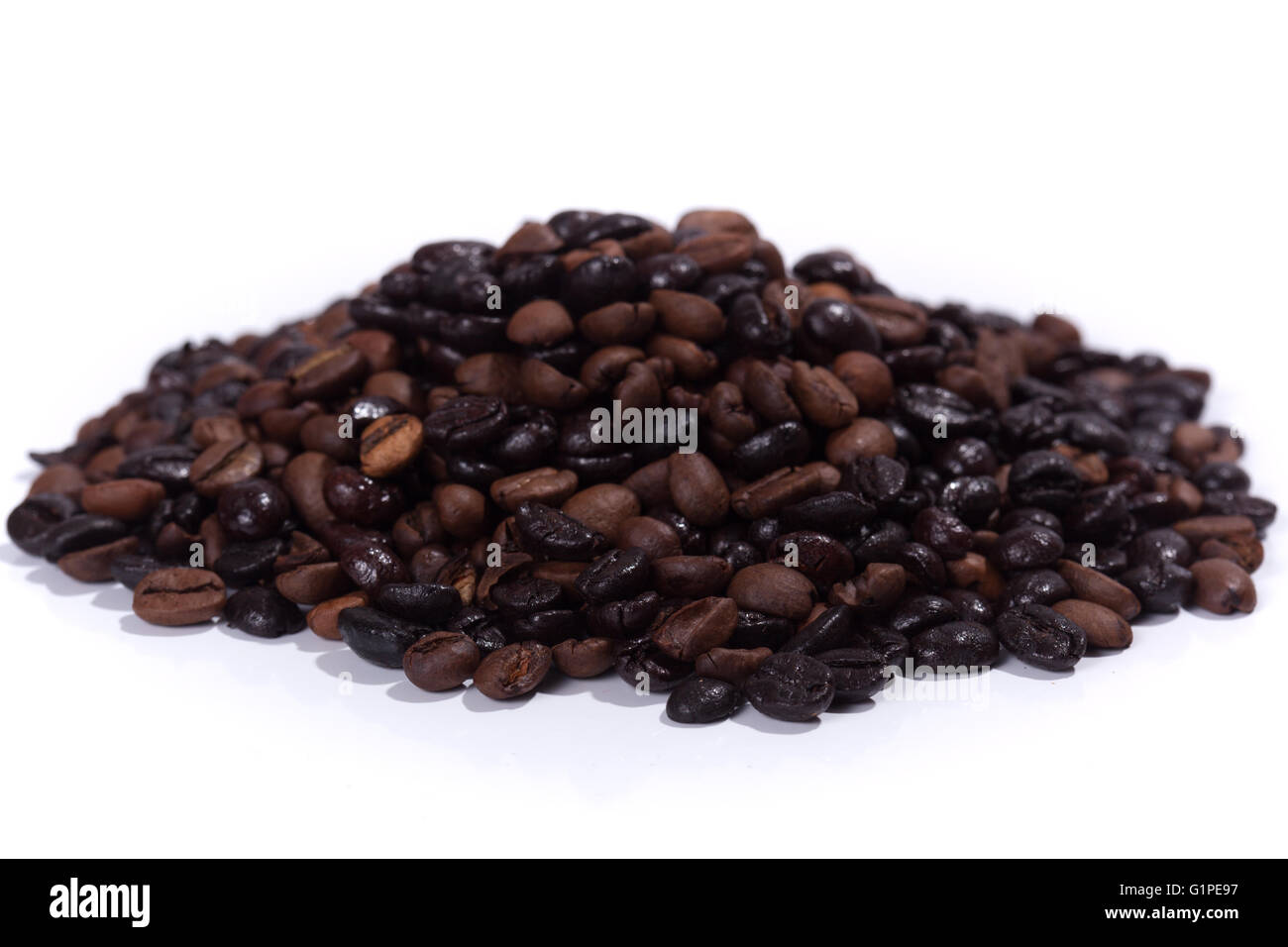 Dark roasted coffee beans, isolated on white background Stock Photo - Alamy