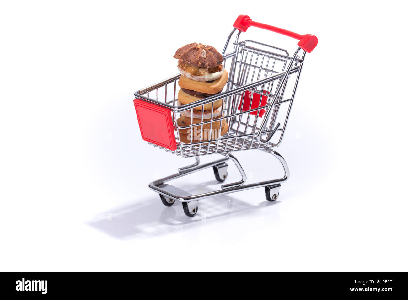Shopping cart with cookies, isolated on white background Stock Photo