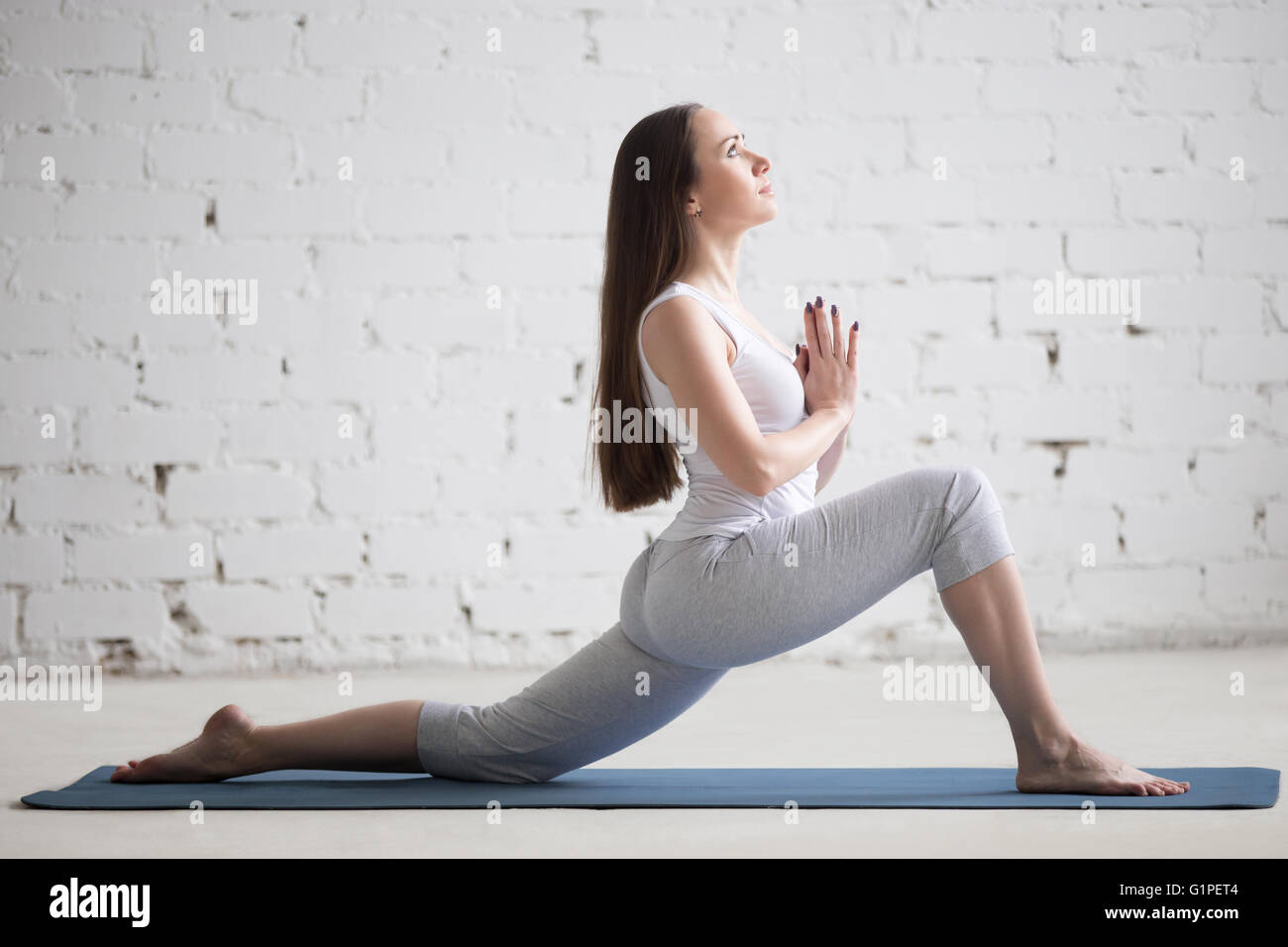 Portrait Of Beautiful Young Woman Doing Yoga At Home. Stock Photo