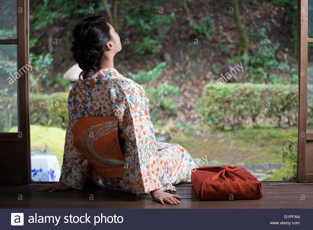 Young Woman In Kimono Sitting High Resolution Stock Photography and