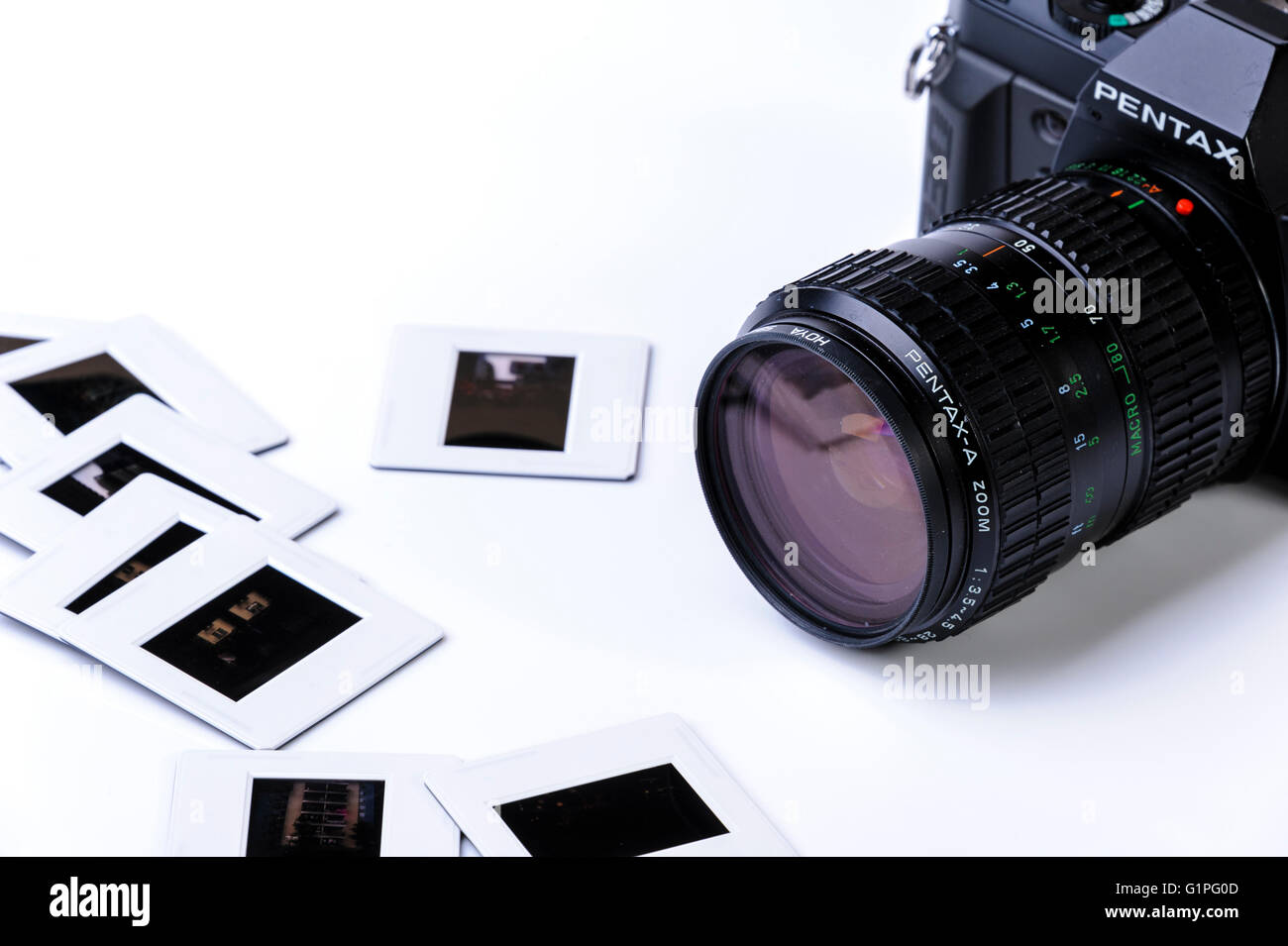 Old 35mm film camera and some mounted transparencies. Stock Photo