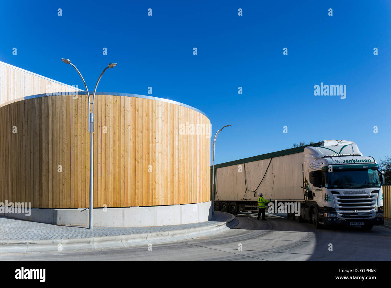 Curved timber cladding of recycling halls and transfer of recycable goods. Bridport Recycling Centre, Bridport, United Kingdom. Stock Photo